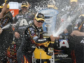 Jeff Gordon sprays champagne after his victory in the NASCAR Sprint Cup Series Pure Michigan 400 auto race at Michigan International Speedway in Brooklyn, Mich., Sunday, Aug. 17, 2014.