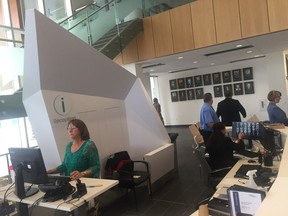 Employees work at the welcome desk at Windsor's new city hall shortly after the facility opened to the public Tuesday, May 22, 2018.