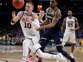 FILE - In this Monday, April 2, 2018 file photo, Villanova's Donte DiVincenzo (10) chases the loose ball against Michigan's Charles Matthews (1) during the second half in the championship game of the Final Four NCAA college basketball tournament in San Antonio. NBA draft decisions by underclassmen will help shape the 2018-19 college basketball season. The winners and losers at the deadline to withdraw from the NBA draft by players who did not hire an agent.