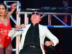 Multi-platinum Cuban-American rapper Pitbull grimaces while performing in Miami in April 2018.