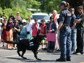 Const. Patti Pastorius demonstrates the abilities of her partner, Windsor police dog Rony, to kids at Windsor Mosque in 2014.