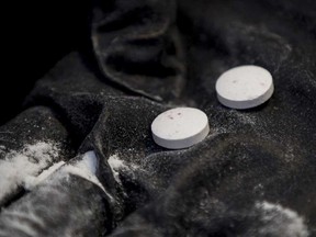 Pills and powder meant to show fentanyl processing in a demonstration by the Calgary Police Service in 2016.