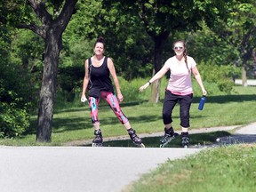 Rollerbladers Heather McCallum, left, and Amie Attar enjoy Windsor's Ganatchio Trail despite a special weather statement for heat on May 28, 2018.