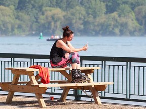 Windsor resident Heather McCallum takes a break from rollerblading at Sand Point Beach in Windsor on May 28, 2018. The city and region was subject to a special weather statement for heat.