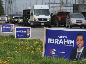 Signs for Windsor West candidate Adam Ibrahim are shown on city land along Walker Road at E.C. Row Expressway on May 9, 2018. Municipal bylaws prohibit placing campaign signs on city property.
