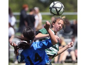 WINDSOR, ON. MAY 16, 2018. --  Lauren Hodgins, right, of the Lajeunesse Royals and Zohra Tabti of the Lamothe-Cadillac Falcons battle for the ball on Wednesday, May 16, 2018, during the WECSSAA senior girls' A soccer final in Windsor, ON. (DAN JANISSE/The Windsor Star)