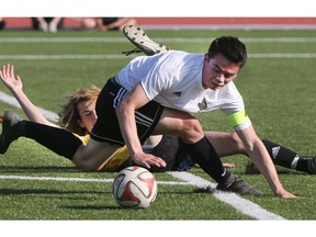 WINDSOR, ON. MAY 24, 2018. --  Jackson Moore of Essex foreground and Nicholas Bozin of General Amherst get tangled up during the WECSSAA boys' AA soccer final on Thursday, May 24, 2018 at the Academie Ste. Cecile in Windsor, ON. (DAN JANISSE/The Windsor Star)