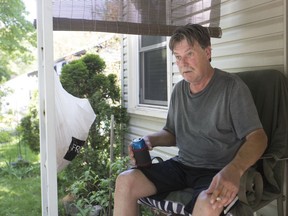 Ken Oriet sits on his porch on Prince Road, where a 4-year-old girl was struck by a Transit Windsor bus Saturday evening.