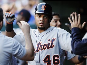 Detroit Tigers' Jeimer Candelario is congratulated by teammates after scoring on a two-run single by designated hitter Victor Martinez, not pictured, during the third inning of a baseball game against the Texas Rangers on May 7, 2018, in Arlington, Texas.