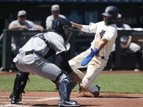 Kansas City Royals' Whit Merrifield, right, safely slides into home plate as Detroit Tigers catcher Grayson Greiner, left, waits for a late throw in the first inning of a baseball game at Kauffman Stadium in Kansas City, Mo., Sunday, May. 6, 2018. Merrifield scored from third off a hit by Mike Moustakas.