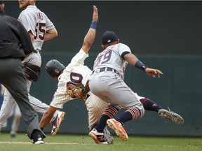Detroit Tigers shortstop Dixon Machado tags out Minnesota Twins left fielder Eddie Rosario to complete a double play in the sixth inning of a baseball game Wednesday, May 23, 2018, in Minneapolis. The Tigers won 4-1.(AP Photo/Bruce Kluckhohn) ORG XMIT: MNBK114