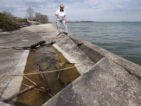 Linda Fraser, inspecting the breakwall in front of her home in the 11000 block of Riverside Dr. E. in Windsor, says the city should replace the 88-year-old crumbling concrete which is causing damage to area homes.