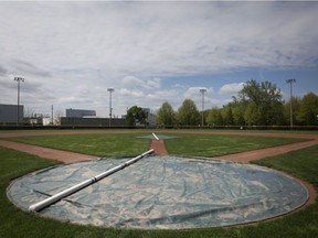 Tarps cover the pitching mound and home plate on a baseball field at Mic Mac Park, Tuesday, May 15, 2018.  Water logged fields are keeping local sports fields closed.