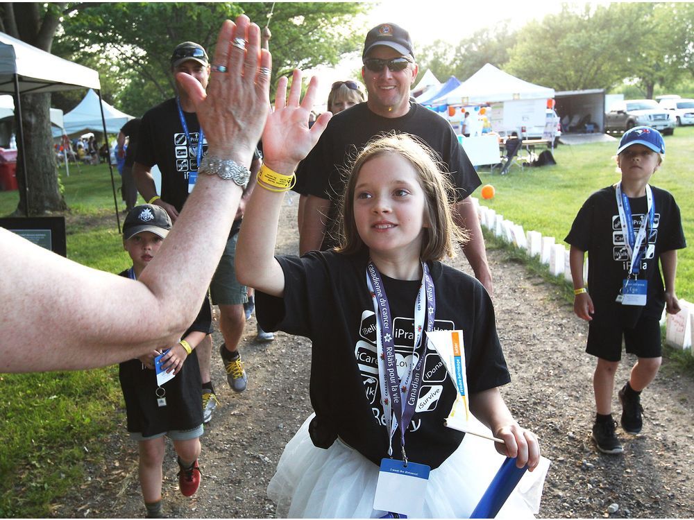 Phoebe Truskey, 10, is congratulated for her big donation of over $8,000 at the Windsor-Essex Relay For Life event at Colasanti's Tropical Gardens on June 8, 2018. Hundreds of enthusiastic supporters cheered as cancer survivors and their families walked.