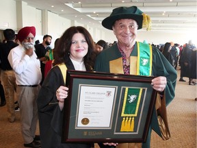 St. Clair College President Patricia France, left, poses with Ted Farron who was awarded an Ontario College Diploma in Culinary Management during St. Clair College's 51st Annual Convocation at St. Clair College Centre for the Arts' Chrysler Theatre  June 11, 2018. Monday's convocation was the first of seven convocations.  Farron was honoured for his continued dedication to the food service industry and his longtime support of St. Clair College and local education.