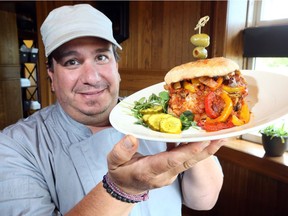 Mettawas Station Italian Mediterranean Grill owner Anthony Del Brocco on June 19, 2018, proudly displays his 'Train Wreck' veal sandwich, a finalist in Ontario's Best Veal Sandwich 2018 competition.