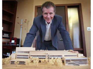 University of Windsor president Dr. Alan Wildeman poses with a model of the engineering school that will built by PCR Contractors Inc. of Windsor.