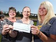 Kim Gauthier, left, mother of Chance Gauthier and Lindsay Trepanier, godmother of Chance Gauthier, donate a cheque for $3,000 to Donna Standel, right, of Windsor Central Little League May 28, 2018.  Active in many sports, Chance Gauthier was 16 when he was murdered in February 2018.