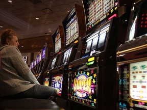 In this file photo, a woman gambles at the MGM Grand Detroit casino. Detroit's casinos enjoyed a bump in revenues during the Caesars Windsor strike.