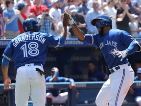 Teoscar Hernandez #37 of the Toronto Blue Jays is congratulated by Curtis Granderson #18 after hitting a two-run home run in the fifth inning during MLB game action against the Baltimore Orioles at Rogers Centre on June 10, 2018 in Toronto, Canada.