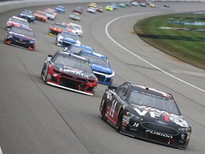 Clint Bowyer leads a pack of cars during the Monster Energy NASCAR Cup Series FireKeepers Casino 400 at Michigan International Speedway on June 10, 2018 in Brooklyn, Michigan.