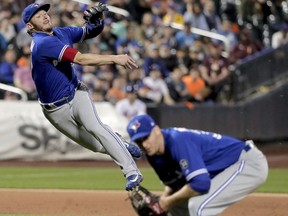 In this May 15, 2018, file photo, Toronto Blue Jays third baseman Josh Donaldson makes an off-balance throw to first but can't get the out on a soft ground ball hit by New York Mets' Juan Lagares during a game in New York.