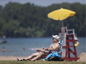 People enjoy the sun and sand at Sand Point Beach on Thursday, July 28, 2018.