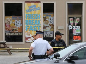 OPP officers are shown outside Break Time Corner Restaurant in Leamington on June 29, 2017, after a woman was found dead inside the prior evening.