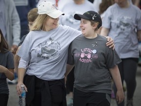 Miranda Mullins, 14, walks with a family friend, Laura Beltran, at the Windsor Brain Tumour Walk at the Riverside Sportsmen's Club on June 9, 2018.