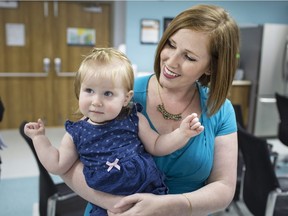Melissa Rudy, a client with the Windsor-Essex County Health Unit, holds her 11-month-old daughter, Sloan, after sharing her story about her struggle to breastfeed at a press conference announcing the health unit's Baby-Friendly Initiative designation, Wednesday, June 20, 2018.