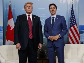 In this June 8, 2018, file photo, U.S. President Donald Trump meets with Canadian Prime Minister Justin Trudeau at the G-7 summit in Charlevoix, Canada. For the first time in decades, one of the world's most durable and amicable alliances faces serious strain as Canadians _ widely seen as some of the nicest, politest people on Earth _ absorb Donald Trump's insults against their prime minister and attacks on their country's trade policies.