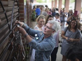 Cancer survivor Andrea Bodchon places a lock on the Healing Garden Wall at the Lock Out Cancer ceremony at Windsor Regional Cancer Centre on June 3, 2018.