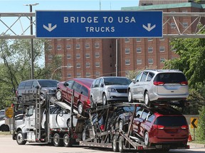 A truck loaded with Chrysler Pacifica models makes its way onto the Ambassador Bridge in Windsor on June 11, 2018.