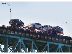 A truck loaded with Chrysler Pacificas built in Windsor is shown heading to the U.S. on the Ambassador Bridge in this June 11, 2018, file photo.