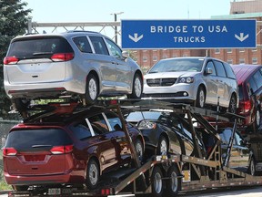 A truck loaded with Chrysler Pacifica models makes its way onto the Ambassador Bridge in Windsor on June 11, 2018.