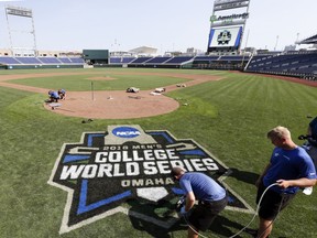 Grounds keepers paint the College World Series logo behind home plate at TD Ameritrade Park in Omaha, Neb., June 14, 2018, where the NCAA College World Series baseball tournament starts on Saturday June 16.