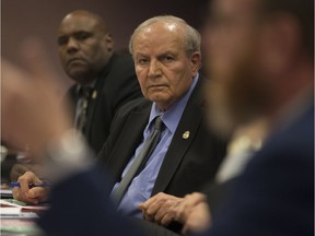 Councillors Ed Sleiman, centre, and John Elliott listen to a colleague during council debate on Dec. 4, 2017. A pair of Millennials have registered to run against the veteran councillor in Ward 5 in this fall's municipal election.