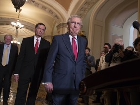 Senate Majority Leader Mitch McConnell, R-Ky., joined by Sen. James Inhofe, R-Okla., a member of the Senate Armed Services Committee, far left, and Sen. John Barrasso, R-Wyo., second from left, arrives for a news conference on Capitol Hill in Washington, Tuesday, June 12, 2018. Republican and Democratic leaders aren't quite celebrating President Donald Trump's historic meeting Tuesday with North Korea's Kim Jong Un, saying the initial agreement they struck won't mean much unless the North completely denuclearizes.