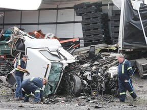 Crews work to clear the scene of a fatal accident involving two transport trucks on the 401 near Tilbury.
