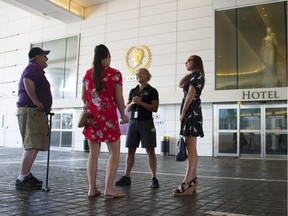 Rick Malewicz (left), and his daughters Morgan (middle) and Kendal (right) speak to a Caesars Windsor employee on June 7, the casino's first day open following a 60-day worker strike.
