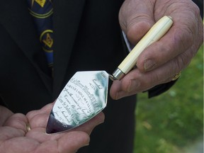 A silver ceremonial trowel is held by Paul Kiddell of Delaware in Sandwich Town on June 7, 2018. Kiddell bought the trowel, made in 1872 for the laying of St John's Church, at a Toronto auction and brought it back to Windsor.