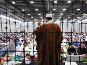 Eid Mubarak! Thousands of all ages from the local Muslim community celebrated Eid al-Fitr, the end of Ramadan, on Friday, June 15, 2018, in a large sports hall at Windsor'se Central Park Athletics. A prayer period followed by food and celebration were enjoyed by participants. Sheikh Mohammad addresses the crowd.