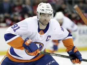 FILE - In this Saturday, March 31, 2018 file photo, New York Islanders center John Tavares skates against the New Jersey Devils during the first period of an NHL hockey game, in Newark, N.J. The NHL's best rarely make it to free agency. Teams tend to re-sign their top players, keeping them off the market and on their rosters. That leaves a slew of solid veterans and journeymen available to the highest bidders trying to find a forward to play on a second or third line, a defenseman to be in a second pairing or perhaps a backup goaltender.