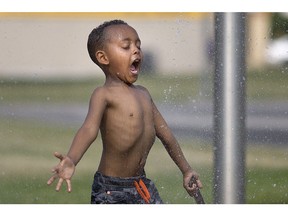 WINDSOR, ONT:. JUNE 17, 2018 -- Herman Mussie, 5, cools off at the Fred Thomas Park splash pad on a record setting hot day, Sunday, June 17, 2018.