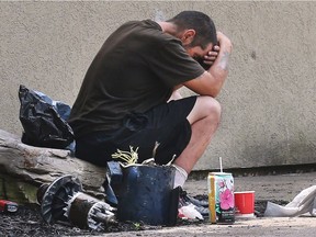 A homeless man sits across the street from the Salvation Army on Park Street West on Wednesday, June 27, 2018 in Windsor, ON.