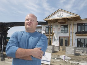 Andre Goulet, a partner with Lakeland Homes, is seen in front of a home under construction in the Seven Lakes area of LaSalle on June 8, 2018. Local housing starts are down but not demand.
