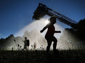 A Windsor Fire Service aerial truck sprays water on area residents at Gary Dugal Park on Drouillard Rd in Windsor during a Hot Summer Night event on July 7, 2017.