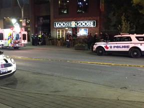 Emergency crews respond to a possible stabbing on the sidewalk in the 100 block of Ouellette Avenue Tuesday night. A call came in to 911 shortly after 9:30 p.m. saying a person had been stabbed in the neck and was vital signs absent.