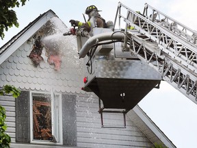 Windsor firefighters are shown at a house fire in the 700 block of Kildare Road on May 23, 2018. City council has approved a new contract which Windsor's firefighters must still ratify.