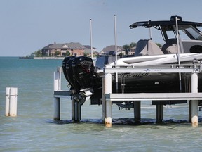 A boat is shown on a lift along Riverside Drive East near the mouth of Lake St. Clair in Windsor on Monday.